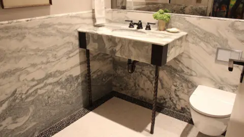 Would you pay $58.5m to live in this iconic New York building? Grace Eliza Goodwin Image of marble bathroom with bathroom sink vanity and steel support legs holding it up