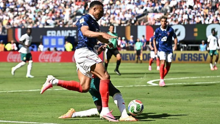 Kylian Mbappe and Sadio Mane challenge for the ball inside the penalty area during France's game with Senegal at the World Cup