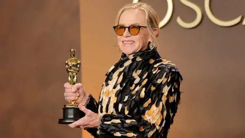 Getty Images Amy Madigan, winner of the Best Actress in a Supporting Role award for “Weapons”, poses in the press room during the 98th Oscars at Dolby Theatre on March 15, 2026 in Hollywood, California.