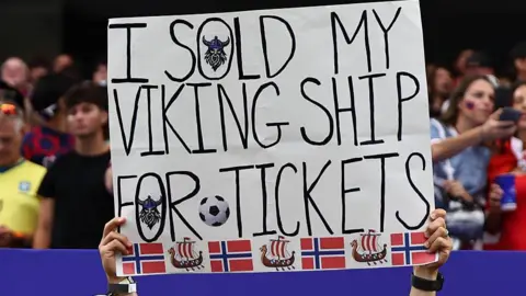 Getty Images A fan of Norway holds up a sign saying they sold their viking ship for tickets to the match during the FIFA World Cup 2026.