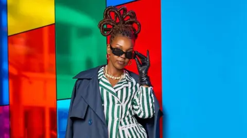 East Africa wants to curb imports of used clothes, but it's not easy Zia Bett Zia Bett poses wearing sunglasses, a striped suit and a blue jacket