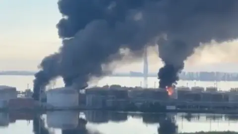 Seven killed after drone hits bus in Russia-controlled part of Ukraine Volodymyr Zelensky/X Phone footage of black smoke rising above the St Petersburg oil terminal, three parts of the facility appear to have been hit.