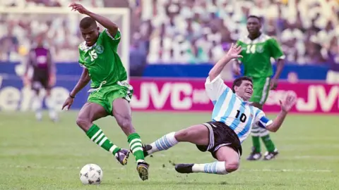 Getty Images  Diego Maradona, playing for the Argentina Men's football team against Nigeria in 1994 in mid air falling to the ground following a challenge.