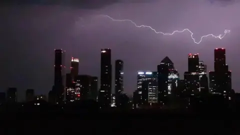 BBC Weather Watcher/SableD Lightning flashes above the London skyline.