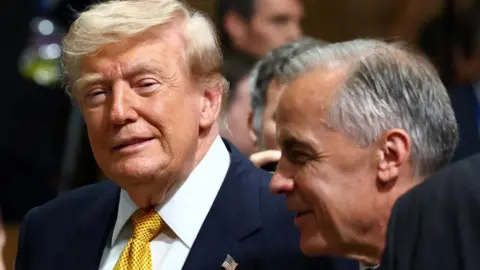Reuters File image of US President Donald Trump and Canadian Prime Minister Mark Carney in conversation at an event