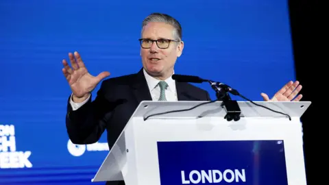 Starmer tells Apple and Google to ban nude images on children's phones Getty Images Sir Keir Starmer talking at a lectern which says London in white writing against a blue background