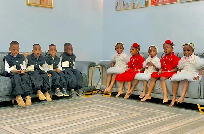 the nonuplets sitting on sofas
