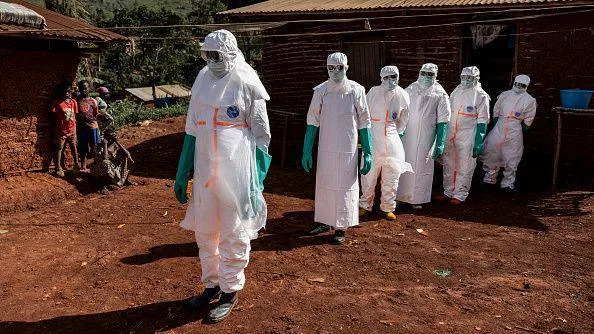 DR Congo seek World Cup ticket refunds after Ebola outbreak Health workers wearing white protective equipment stand during safe burial procedures outside a family home in the community of Mongbwaluon in the Democratic Republic of Congo.
