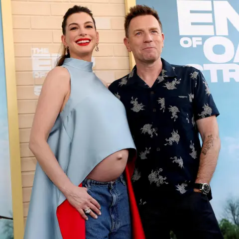 Anne Hathaway pokes fun at 'fake baby bump' theories Reuters Anne Hathaway and Ewan McGregor posing together on the red carpet