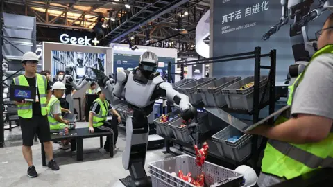 The Chinese robot army transforming the UK's retail industry Getty Images Humanoid robots demonstrate picking and material handling