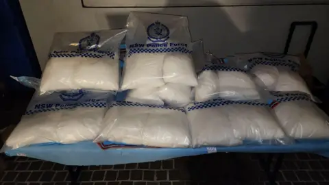 NSW Police Force Several bags containing white powder sitting on a table.