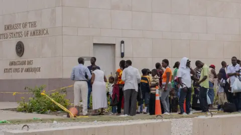 Getty Images A crowd lines up outside the American embassy in Haiti 