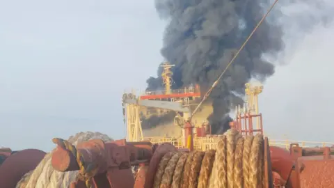 I survived a missile strike in the Strait of Hormuz, but my friend has not been found Sunil Pereira Smoke and flamies plume from the bow of Skylight after it was hit by a missile