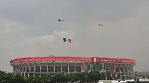 AFP via Getty Images Mexican Air Force helicopters with a Mexican flag fly over the opening ceremony ahead of the 2026 World Cup Group A football match between Mexico and South Africa