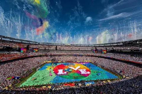 Getty Images A wide shot of the stadium with a colourful stage in the centre and the word "love" written in the middle