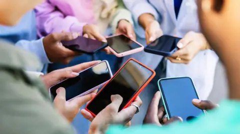 Amsterdam bans public adverts for meat and fossil fuels Getty Images Students on their mobile phones