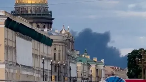 Seven killed after drone hits bus in Russia-controlled part of Ukraine Reuters A picture taken from the ground where Black smoke can be seen rising over a golden-domed building in the Russian city of St Petersburg.