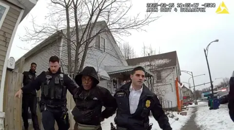 Buffalo Police Department/AP Image from body camera video provided by the Buffalo Police Department shows Nurul Amin Shah Alam led by Buffalo Police officers on 15 February