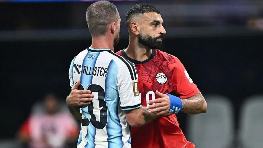 Egypt's Mohamed Salah embraces his former Liverpool team-mate Alexis Mac Allister after full-time in the World Cup last-16 match with Argentina