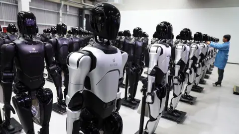 The Chinese robot army transforming the UK's retail industry Getty Images An engineer debugs robots at the factory of AgiBot, a leading robotics company