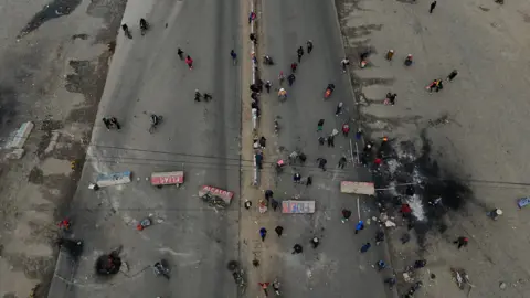 Getty Images Aerial view shows demonstrators blocking a road during a protest against the government in El Alto
