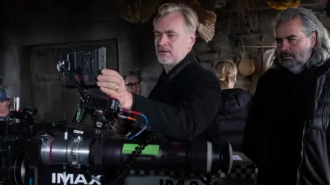Universal Studios Director Christopher Nolan pictured with an IMAX camera on the set of The Odyssey