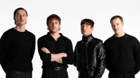 PA Media Harris Dickinson as John Lennon, Paul Mescal as Paul McCartney, Barry Keoghan as Ringo Starr, and Joseph Quinn as George Harrison. All are wearing black tops.