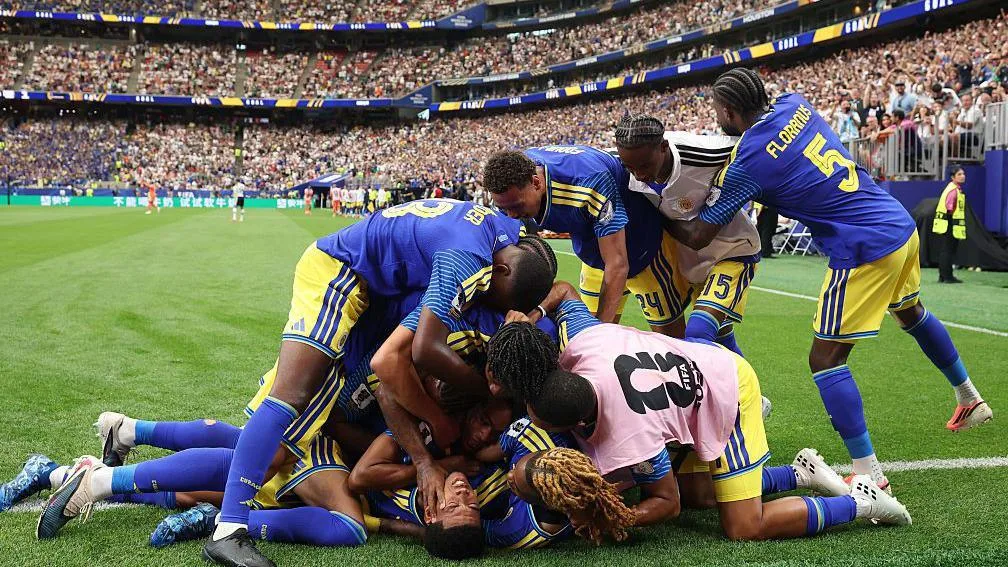 Livano Comenencia is mobbed by teammates after scoring Curacao's first ever World Cup goal