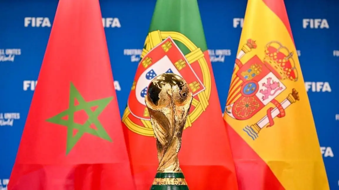 A promo shot for the World Cup sees the golden trophy sitting front and centre in the foreground of the image while the flags of the three 2030 joint hosts, Morocco, Portugal and Spain, are ranged from left to right respectively overlapping in the background in front of a blue board while displays the word Fifa in white lettering
