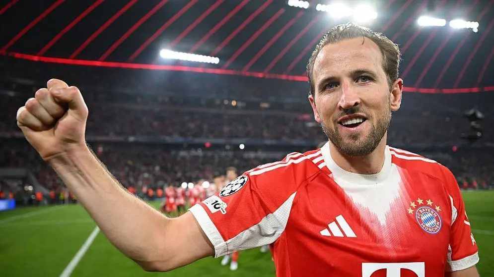 Harry Kane smiles and punches the air