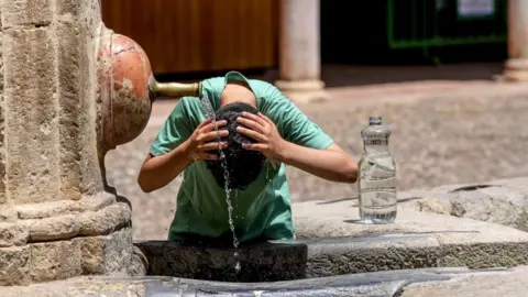 EPA Tourist cooling off in fountain in Cordoba, Spain on 22 June 2026