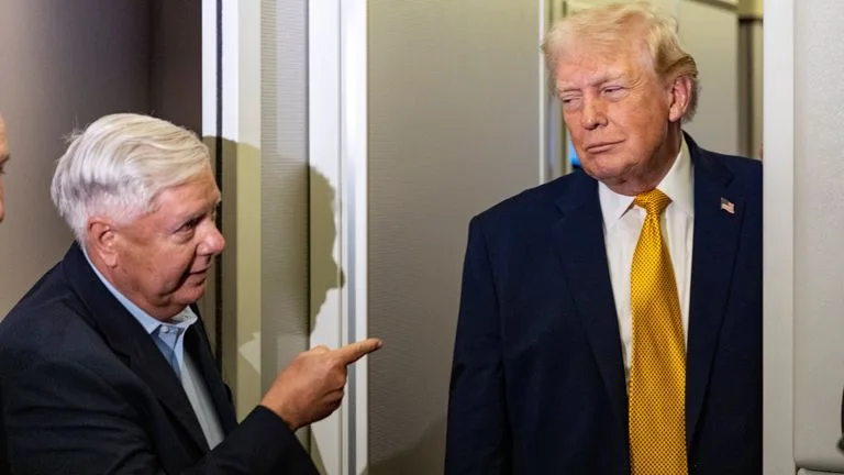 Lindsey Graham and Donald Trump aboard Air Force One in January. Pic: AP 