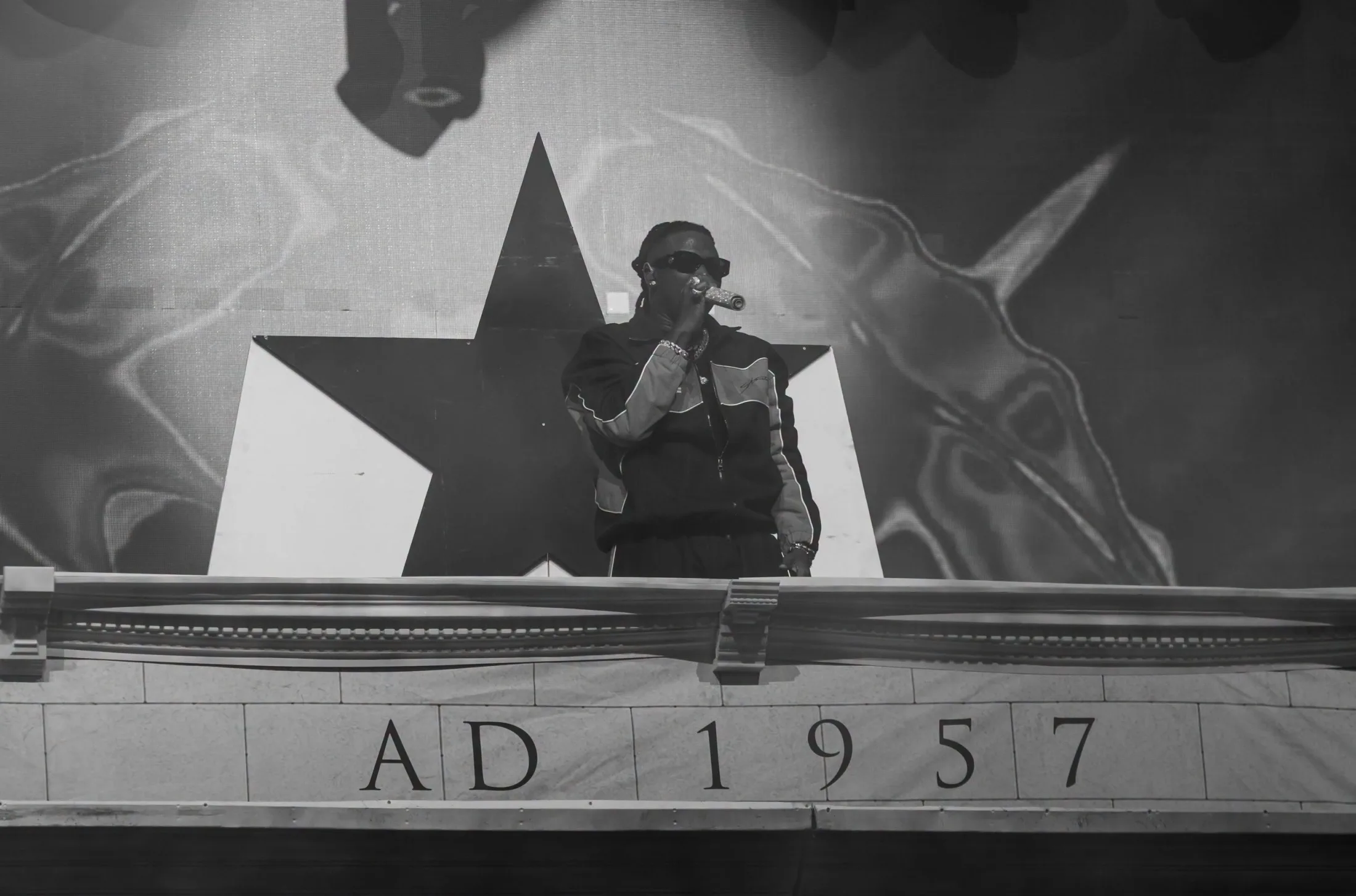May be a black-and-white image of saxophone, crowd and text that says 'AD1957 957 AD 1'