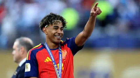 IMAGN IMAGES/Reuters Spain's Lamine Yamal celebrates after winning the World Cup. He is pointing up and smiling
