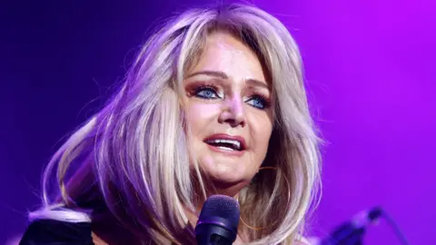 Getty Images Bonnie Tyler singing on stage in 2021