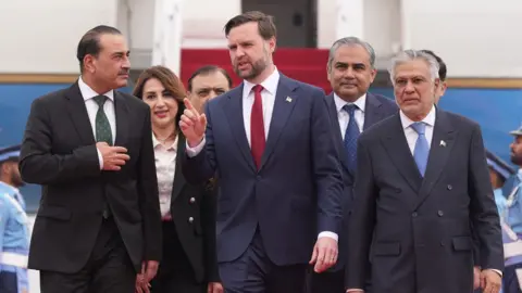 Getty Images U.S. Vice President JD Vance (C) walks with Pakistan's Chief of Defence Forces and Chief of Army Staff Field Marshall Asim Munir (L), and Pakistani Deputy Prime Minister and Foreign Minister Mohammad Ishaq Dar after arriving for talks with Iranian officials 