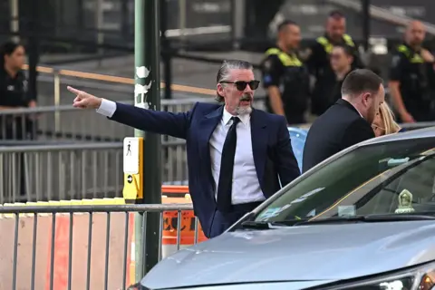 Taylor Swift and Travis Kelce wed in NYC in ceremony officiated by Adam Sandler Getty Images Ethan Hawke points his arm as he arrives at Madison Square Garden on 3 July.