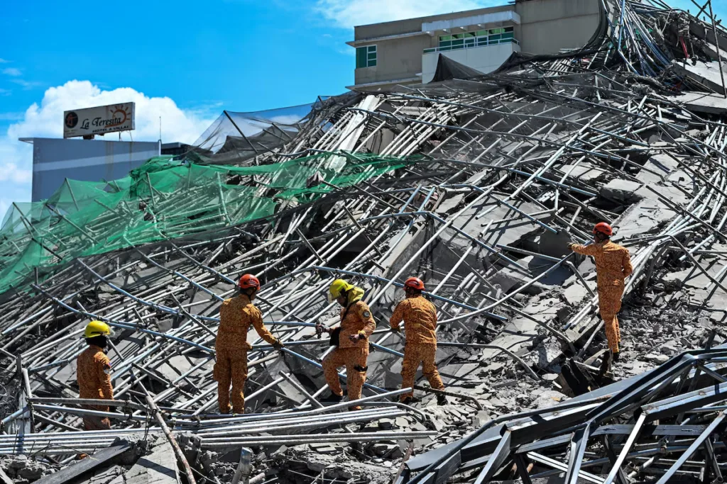 Rescuers search for more than 20 trapped after Philippines building collapse