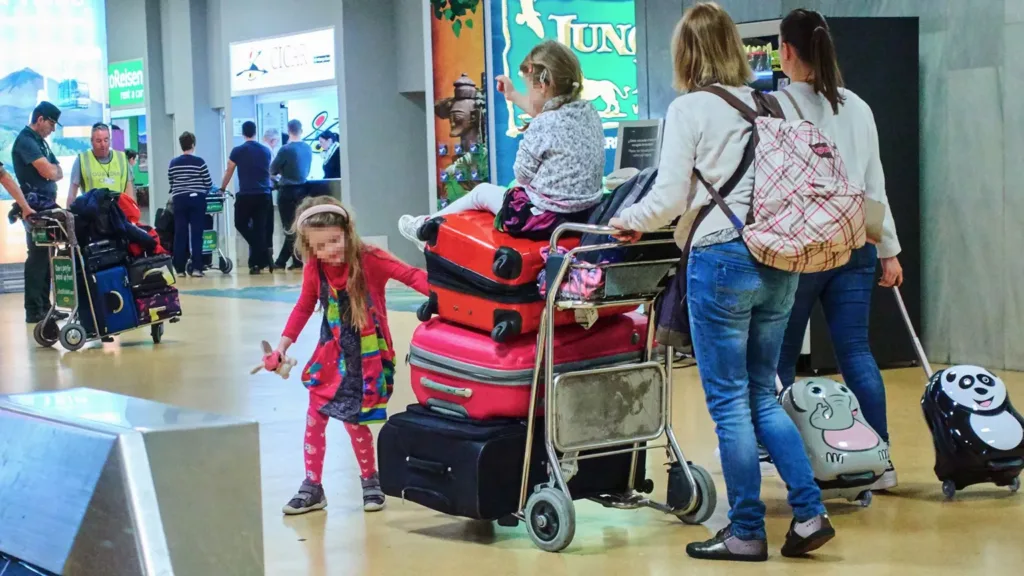 Ryanair says it will reluctantly not charge parents to sit next to children