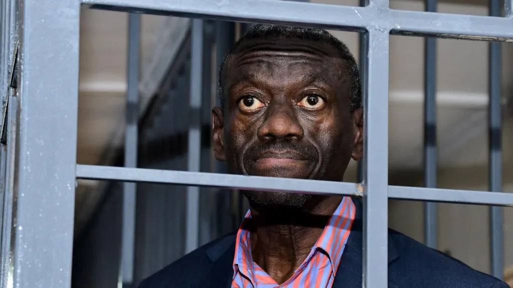 Veteran Ugandan opposition politician collapses in court and in ICU, his wife says