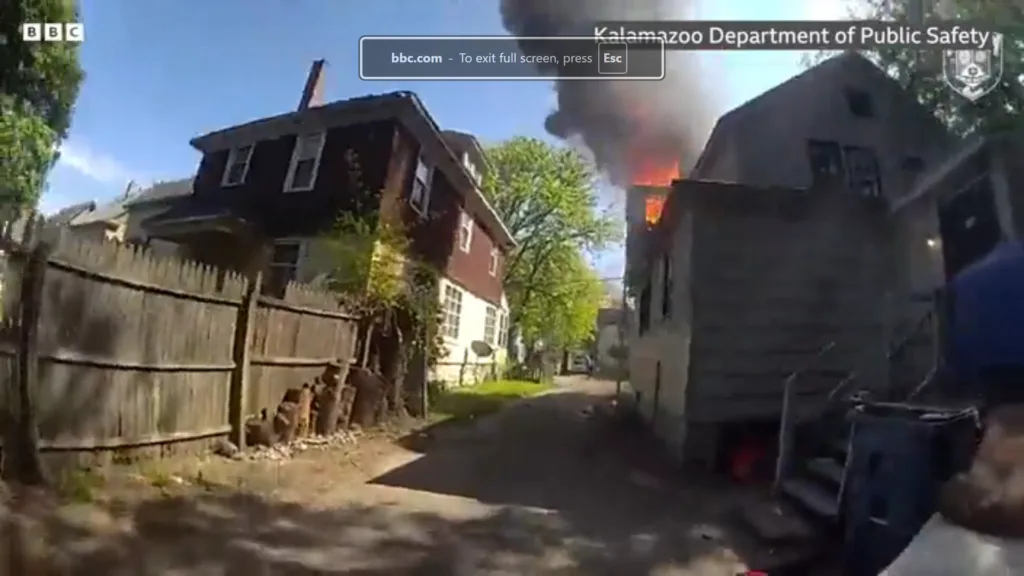 Police officer catches baby dropped from window of burning home
