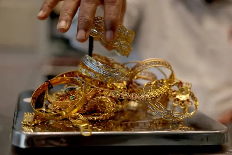 Gold gains on weaker dollar, easing inflation concerns